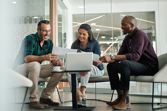 Three people reviewing business documents